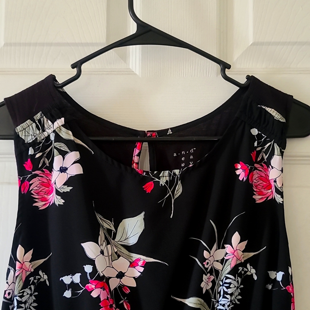 Sleeveless black and floral business casual blouse.